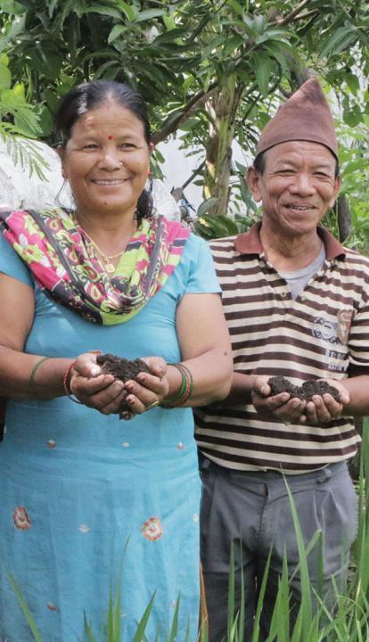 A Nepalese couple holding soil